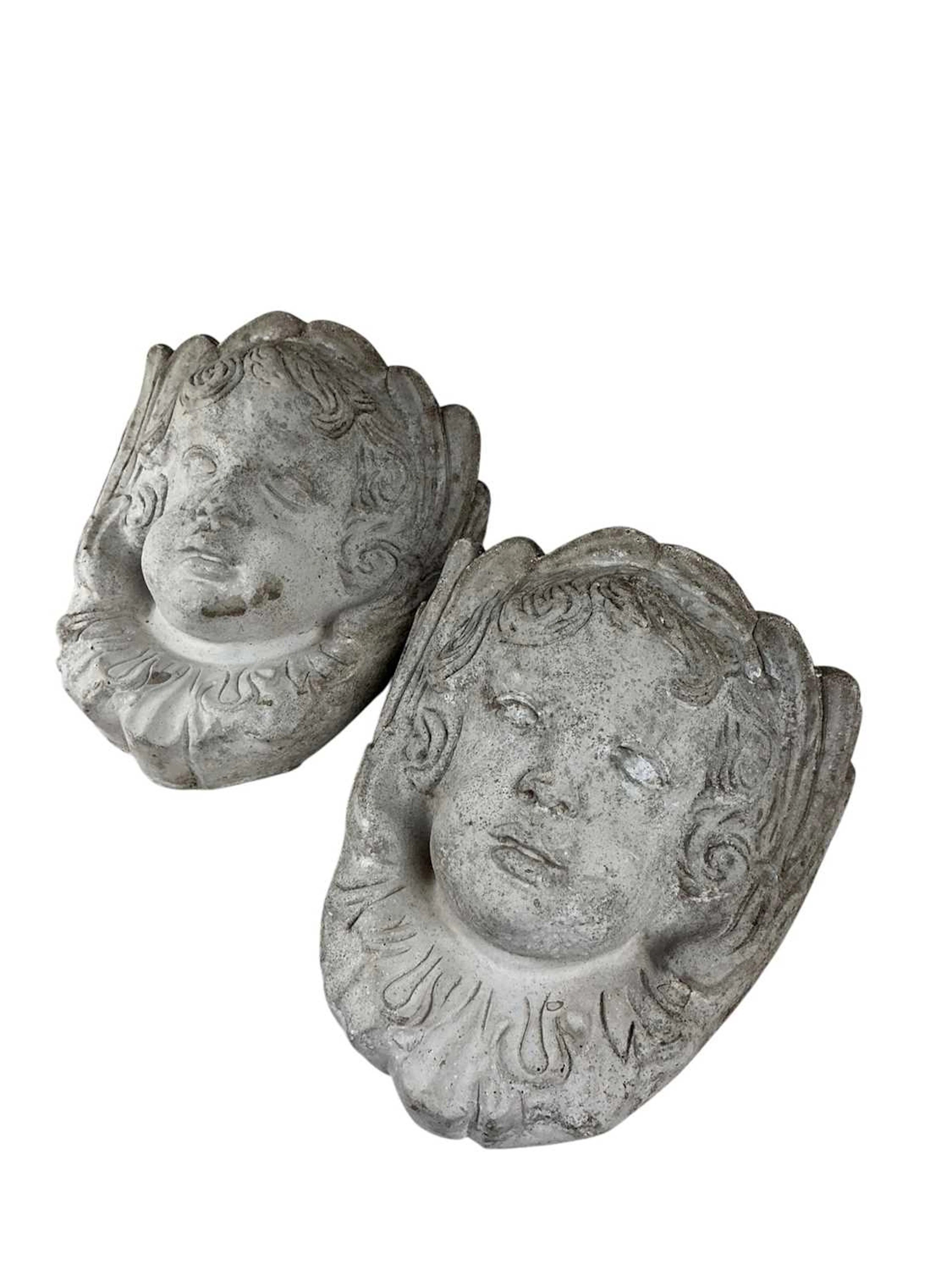 PAIR OF COMPOSITE STONE CHERUB WALL SCONCES MID /LATE 20TH CENTURY