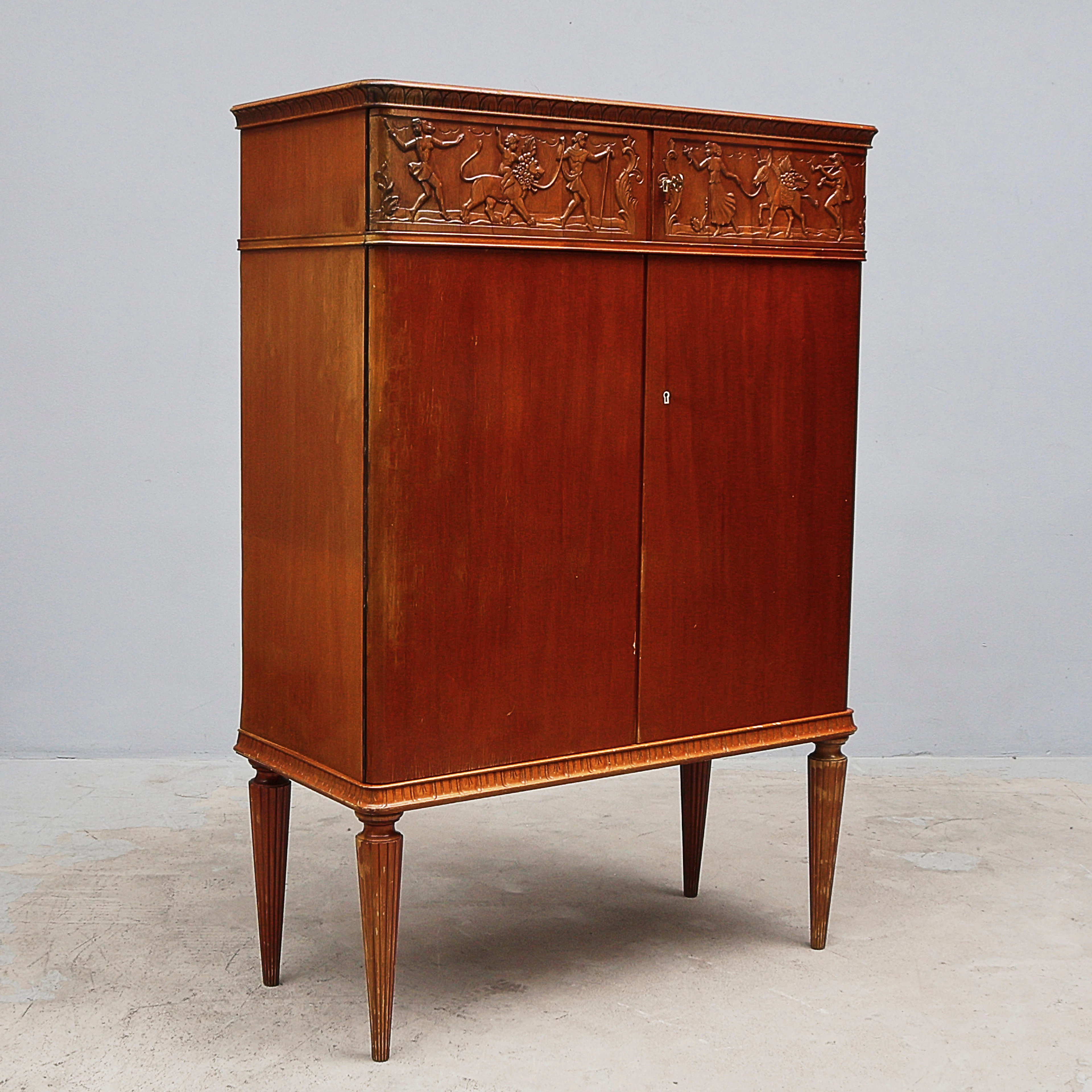 EUGEN HÖGLUND. Skåp, Mahogny, Reliefdekor.