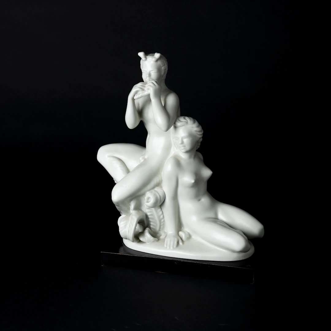 HARALD SALOMON. Figuringrupp, porslin, pan med nymf, porslin, på träsockel