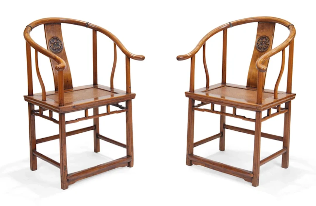 A pair of Chinese elm horseshoe back armchairs