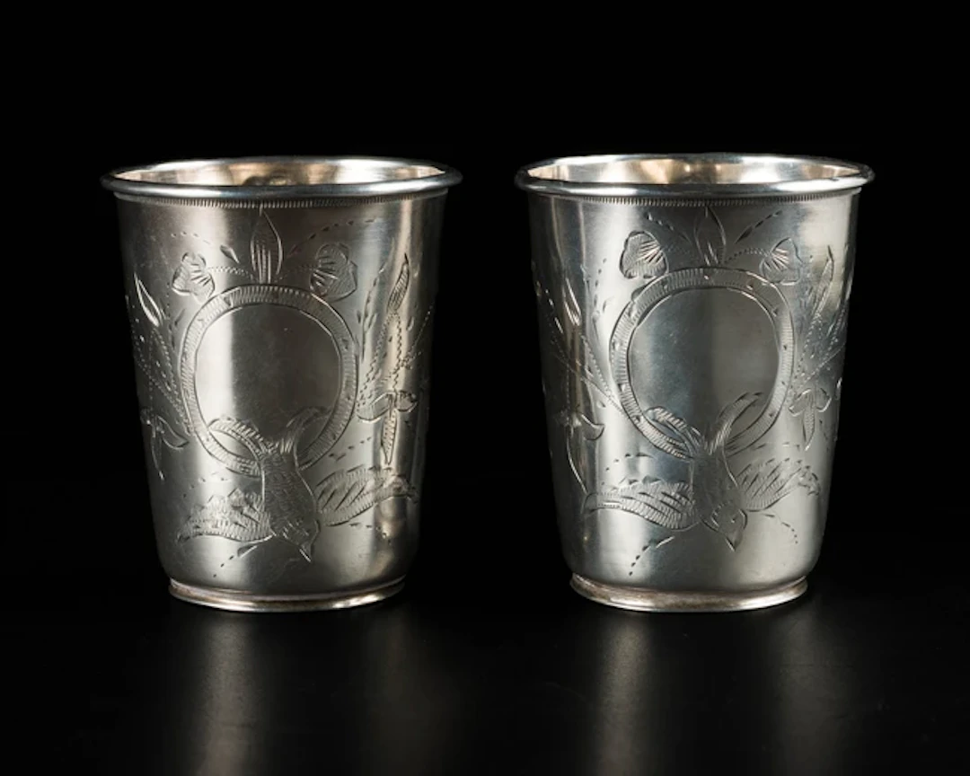 A pair of silver engraved beakers