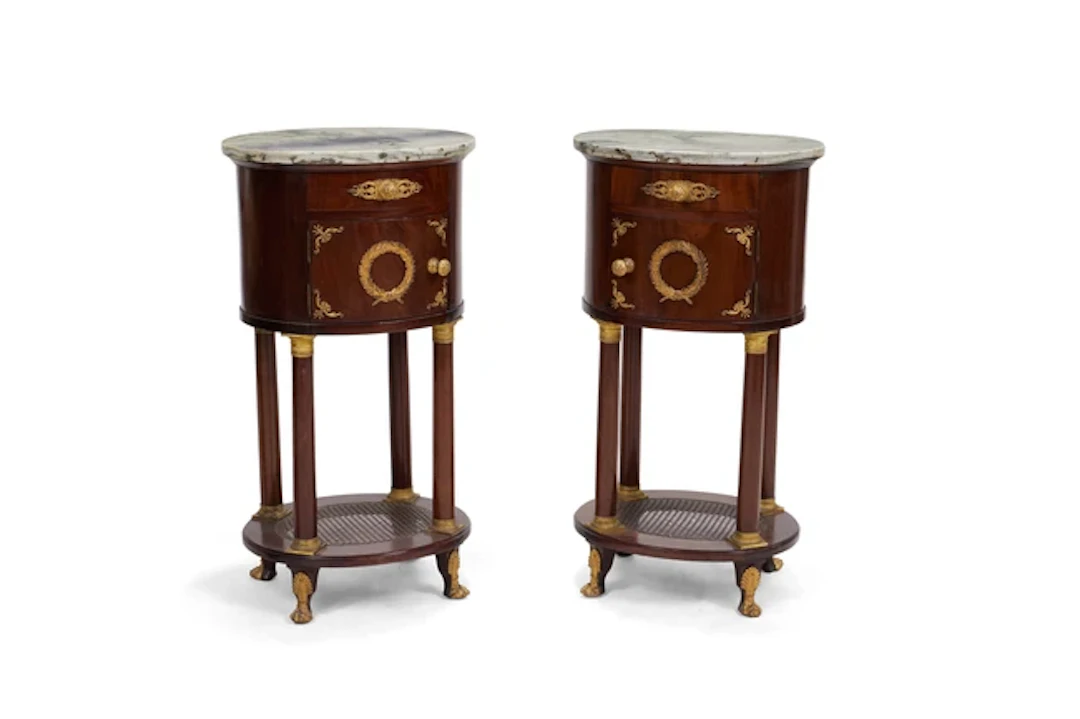 A pair of second Empire gilt-bronze mounted mahogany oval bedside cupboards