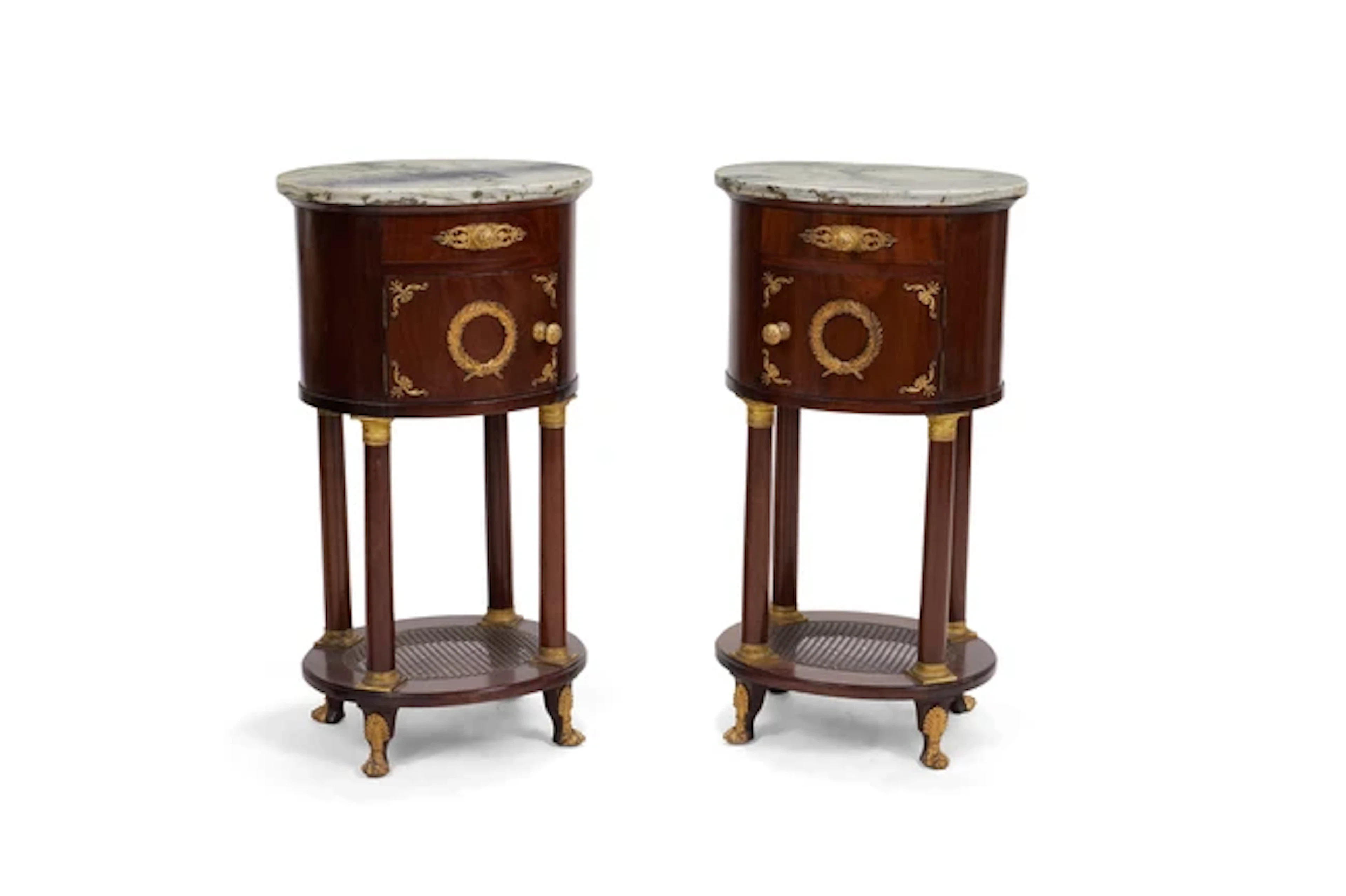 A pair of second Empire gilt-bronze mounted mahogany oval bedside cupboards