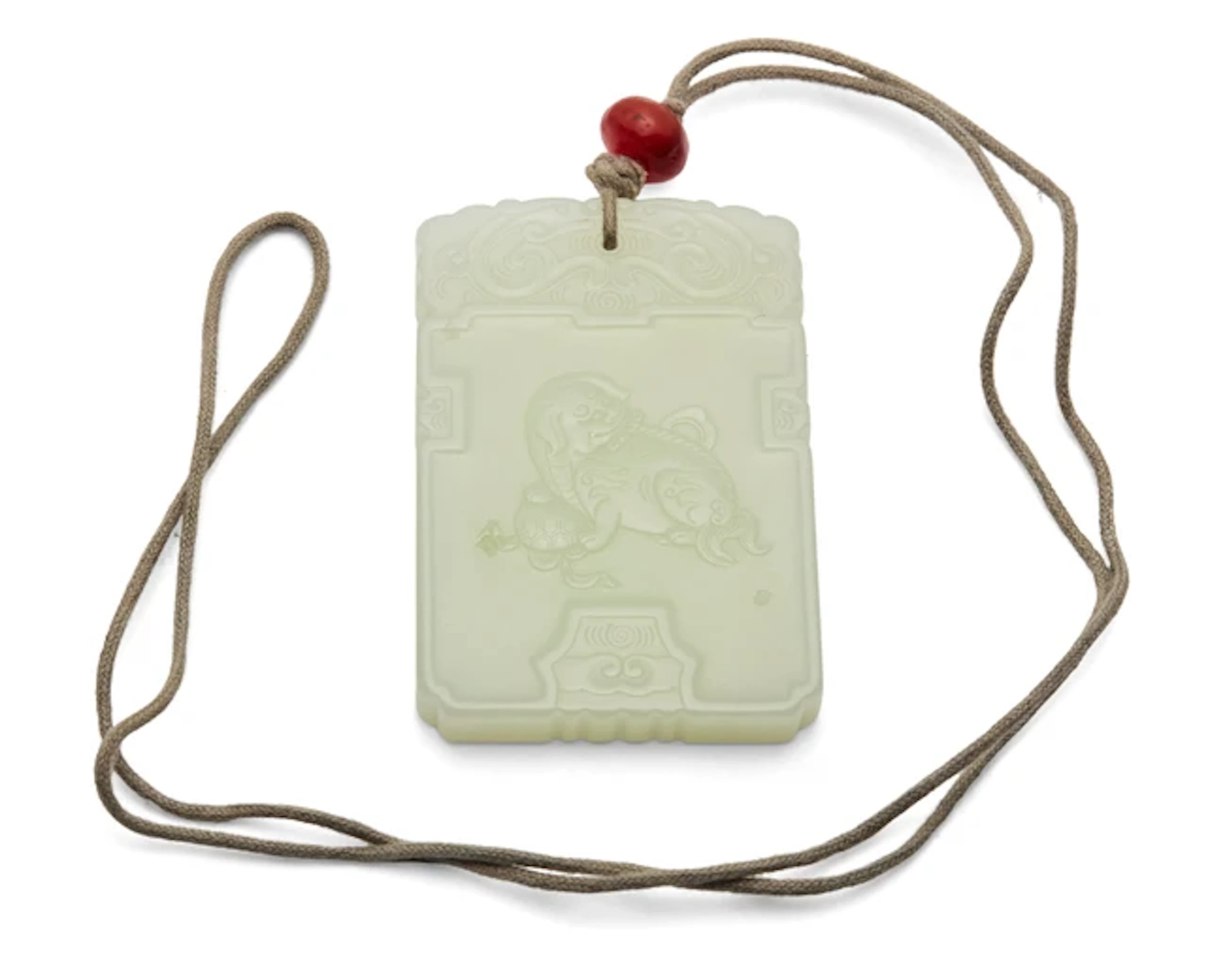 A Chinese white jade 'Buddhist lion' pendant plaque 20th...