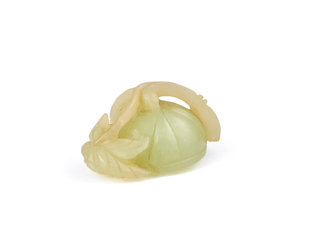 A Chinese pale green jade carving of a lotus pod Qing dynasty
