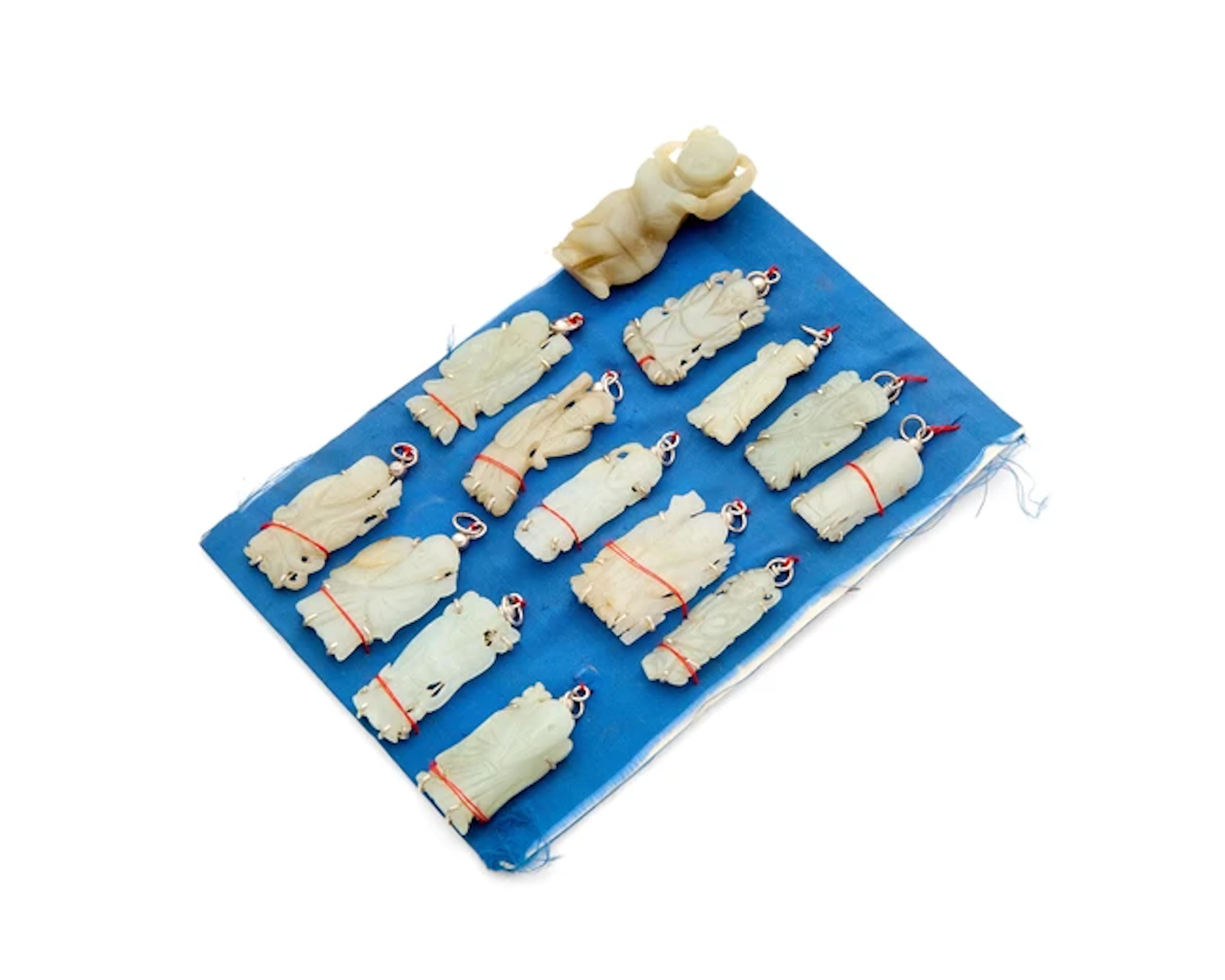 A Chinese jade carving of a boy and thirteen 'immortals' pendants Qing dynasty