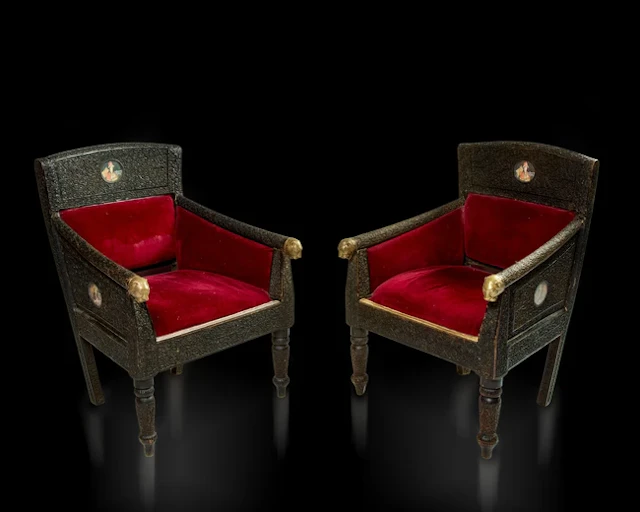 Two carved wood armchairs