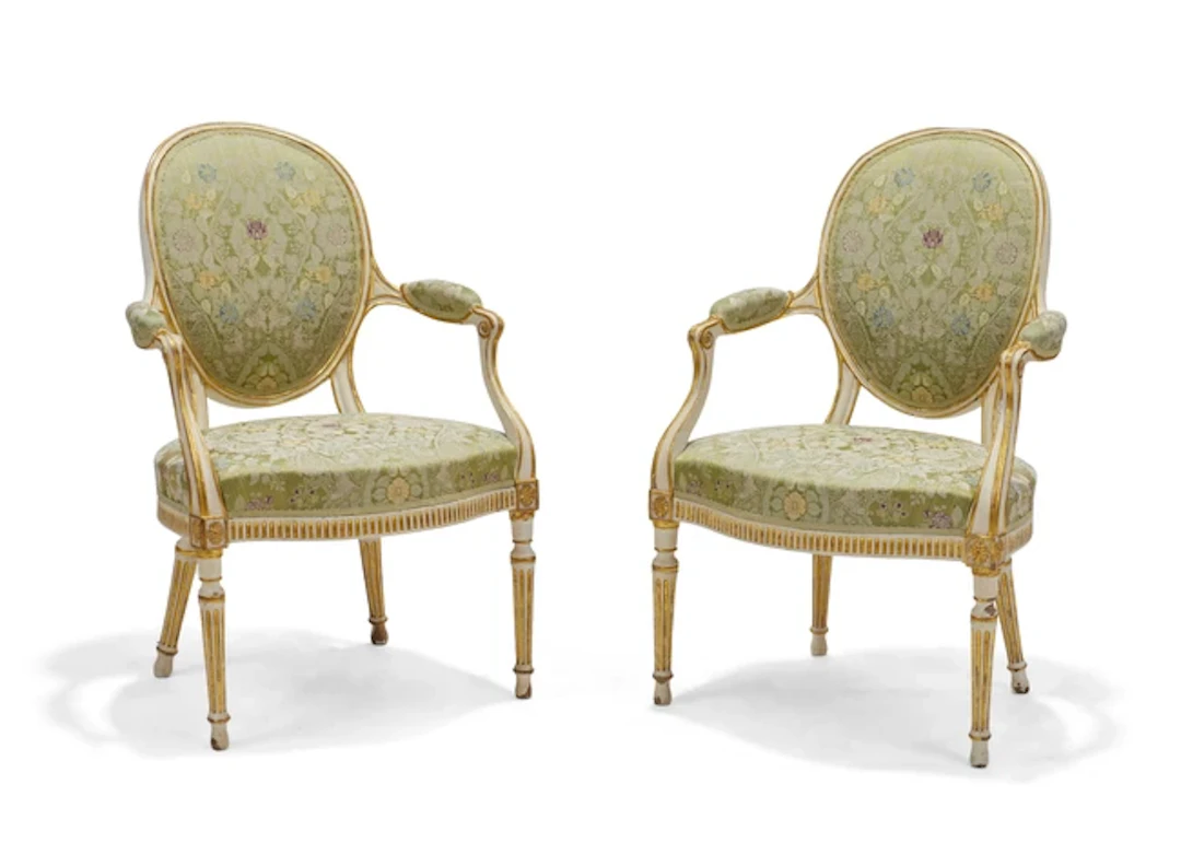 A pair of George III parcel-gilt and cream-painted armchairs
