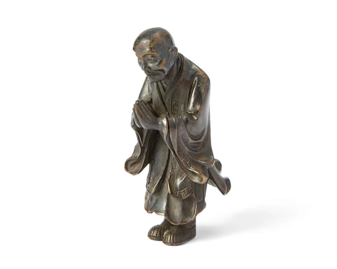A Chinese bronze figure of a luohan Qing dynasty Standing...