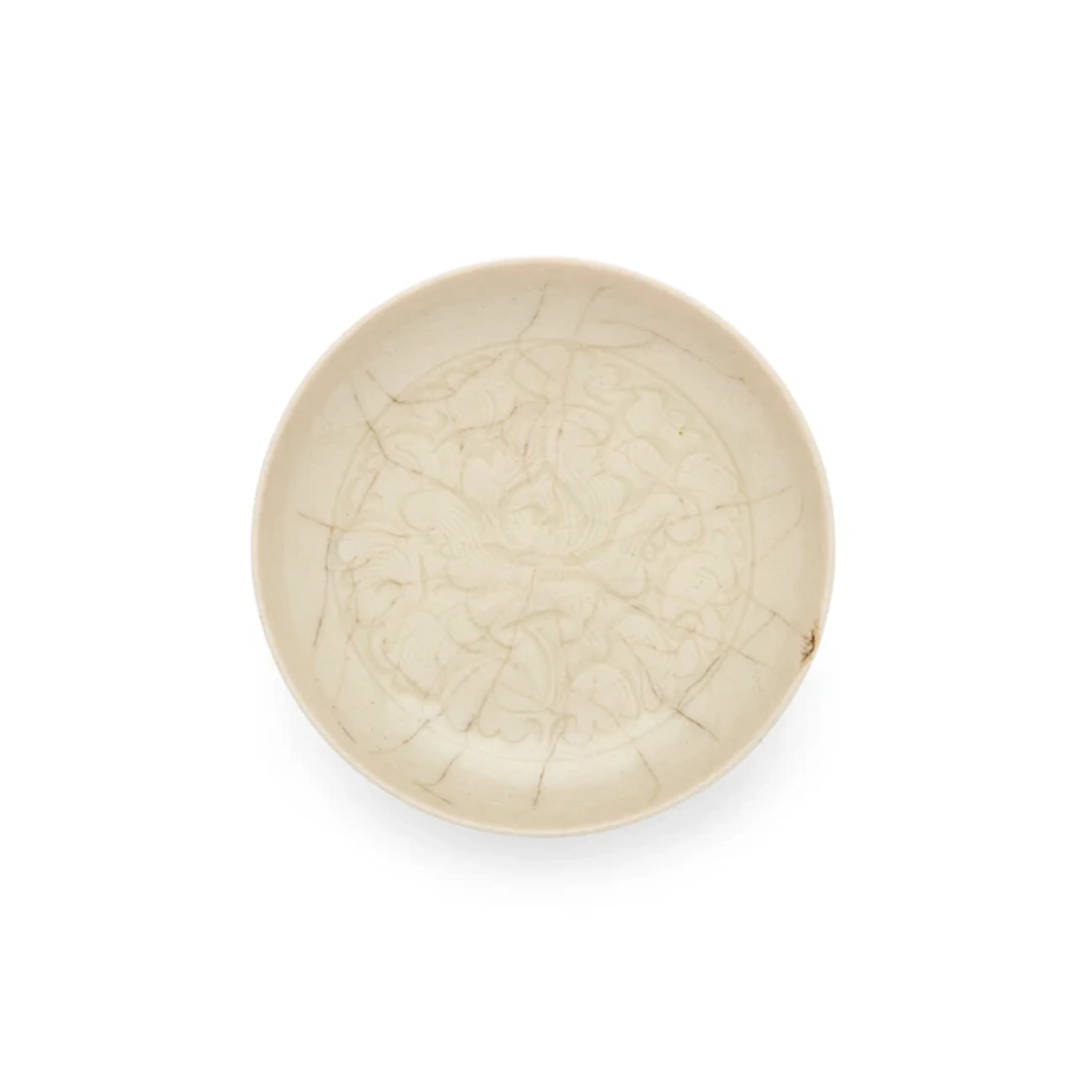 A small Chinese carved white-glazed dish 20th century...