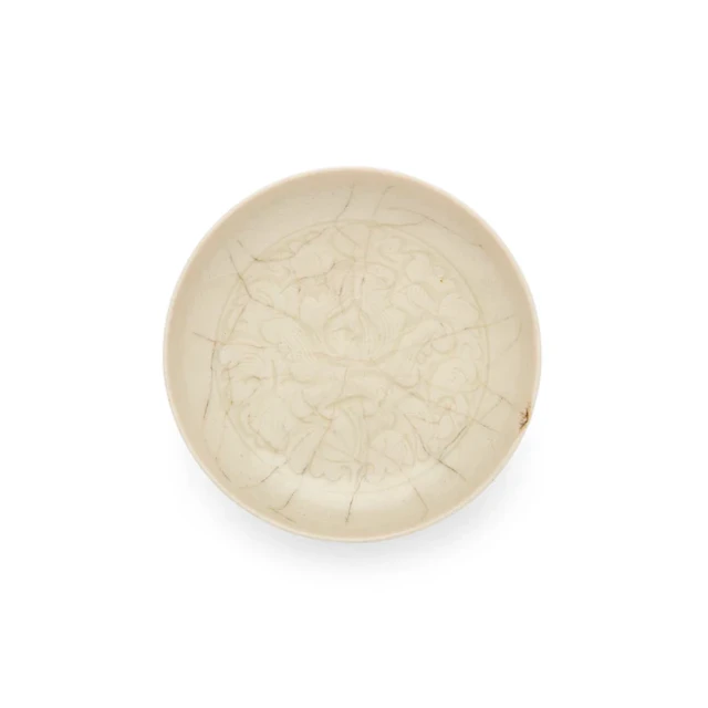 A small Chinese carved white-glazed dish 20th century...