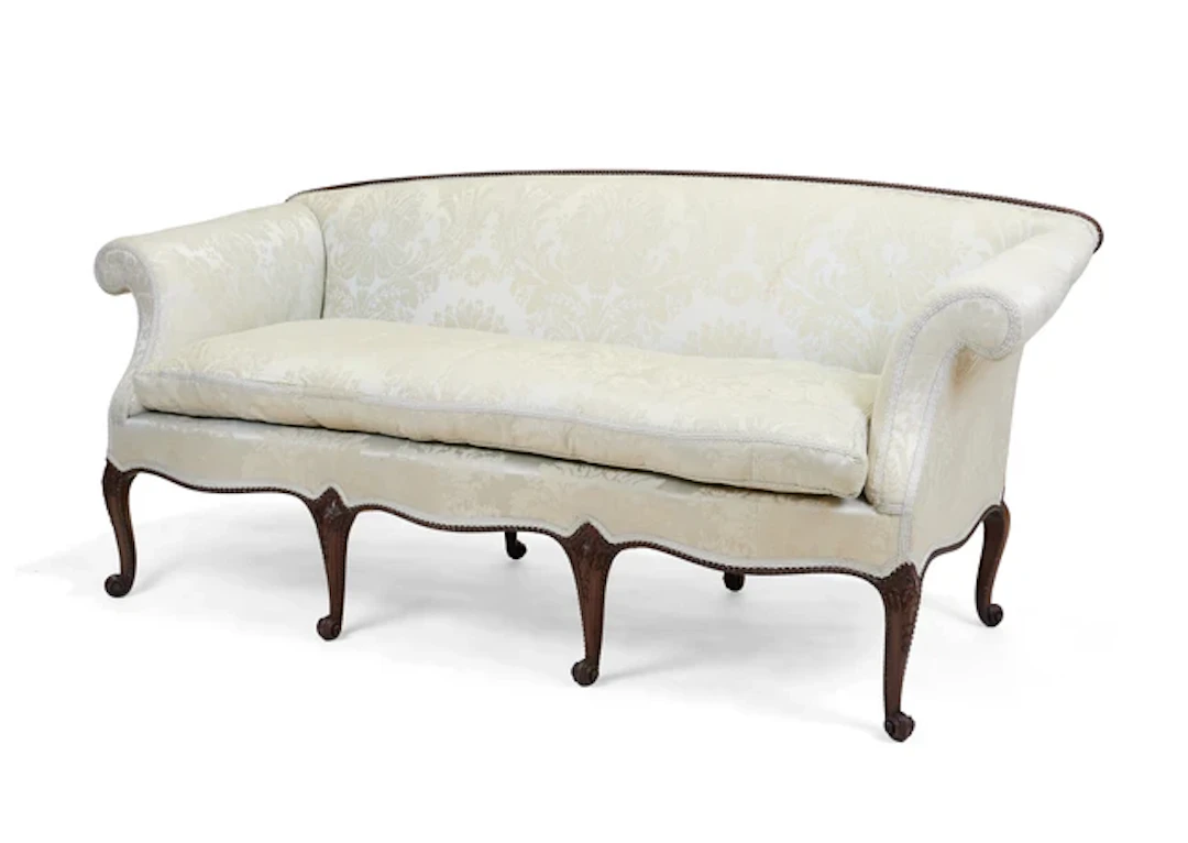 An Edwardian mahogany serpentine front sofa