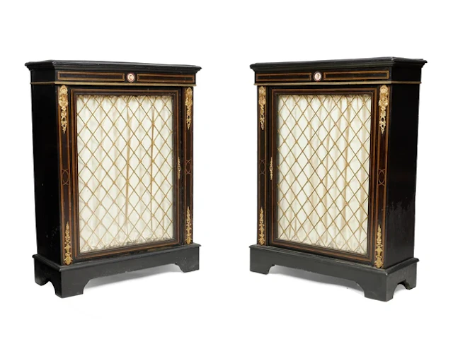 A pair of Victorian gilt-metal mounted boxwood strung ebonised pier cabinets