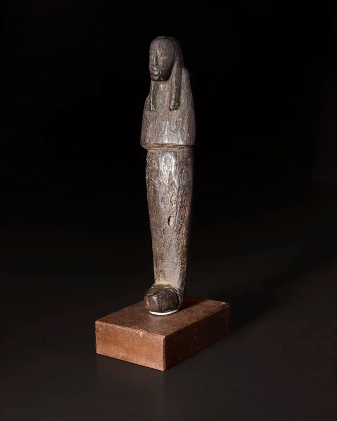 An undecorated Egyptian New Kingdom wood shabti
