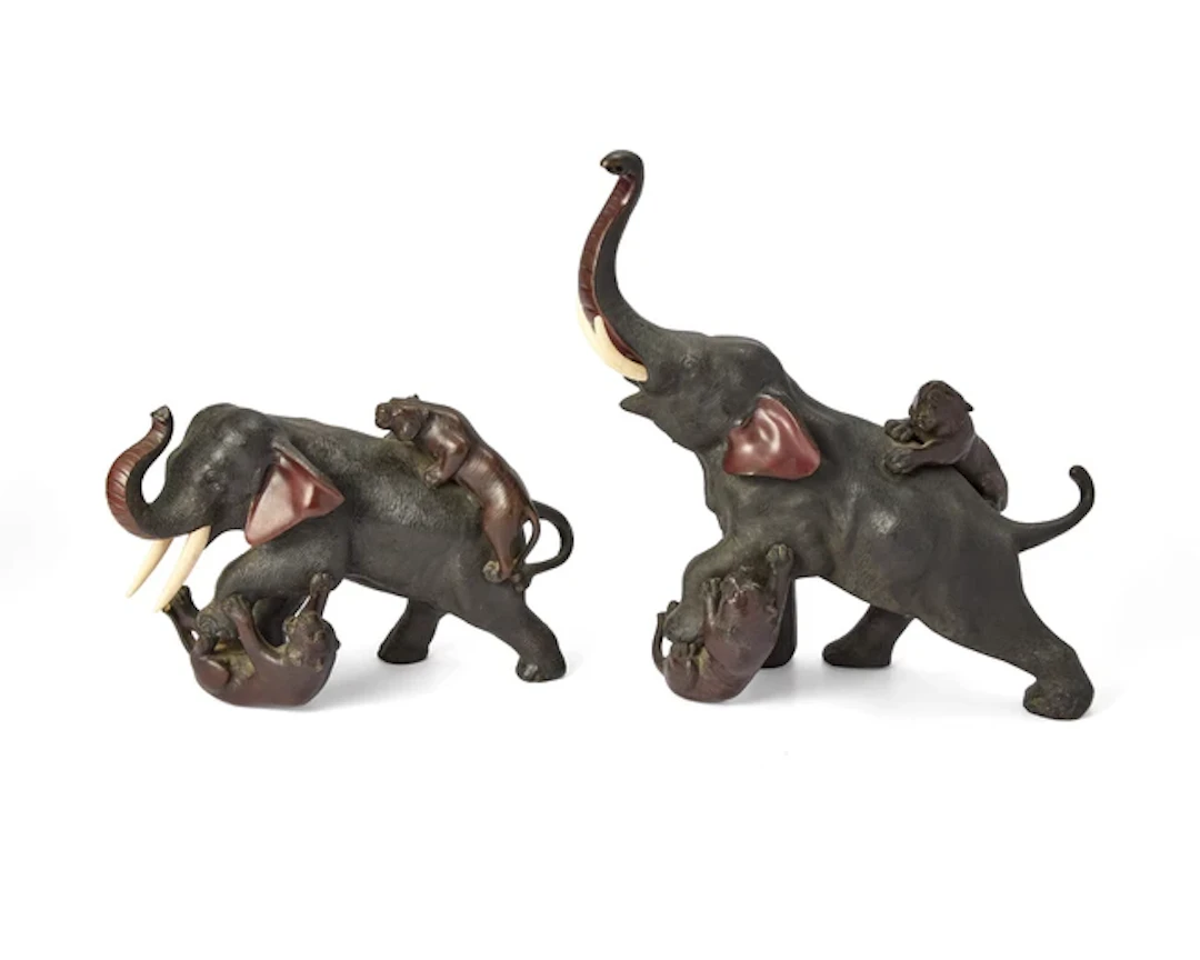 Two Japanese bronze okimono depicting tigers attacking an...