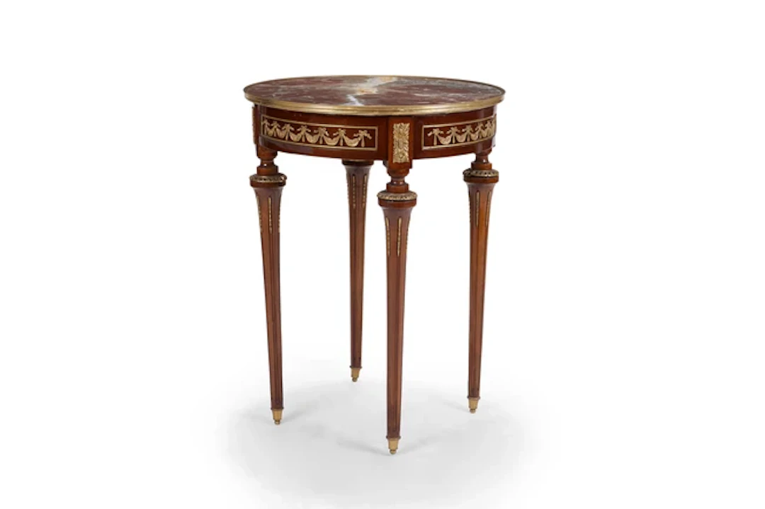 A French gilt-brass mounted stained beech gueridon