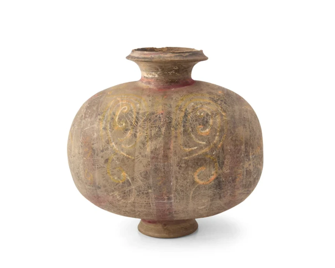 A Chinese painted pottery 'cocoon' jar Han dynasty The...