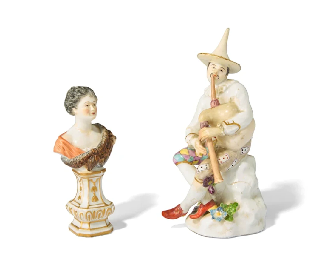 A Meissen porcelain figure of a Harlequin playing the...
