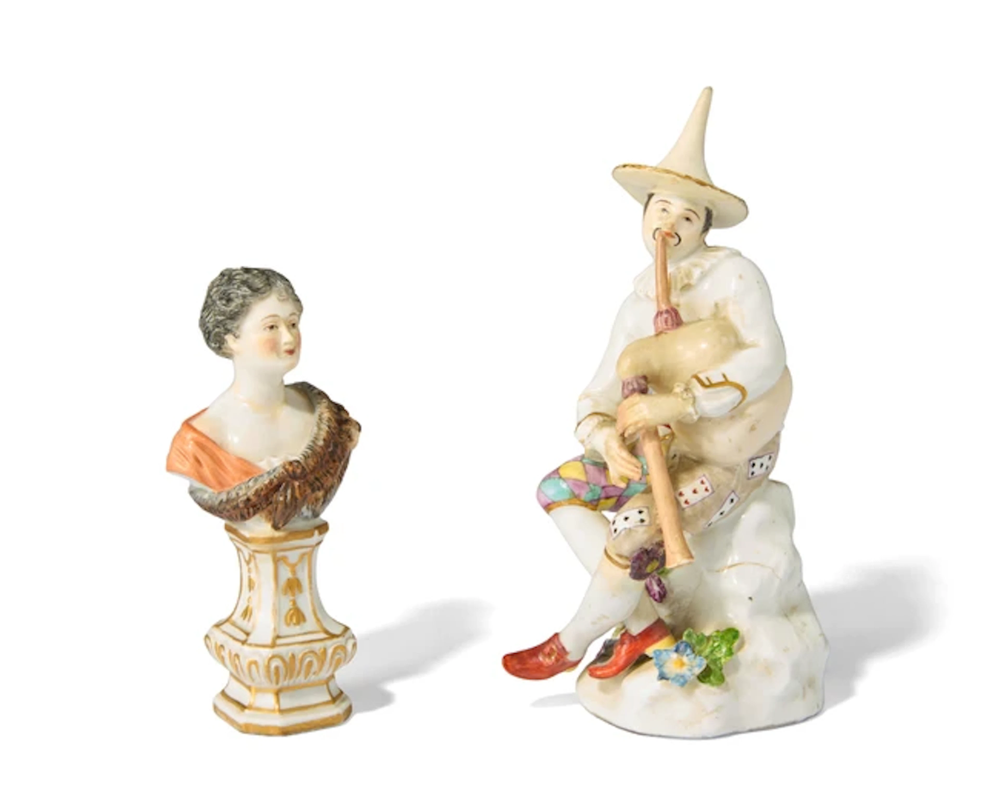 A Meissen porcelain figure of a Harlequin playing the...
