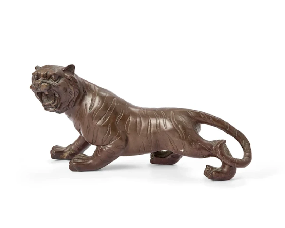 A Japanese bronze okimono of a tiger Meiji period The...