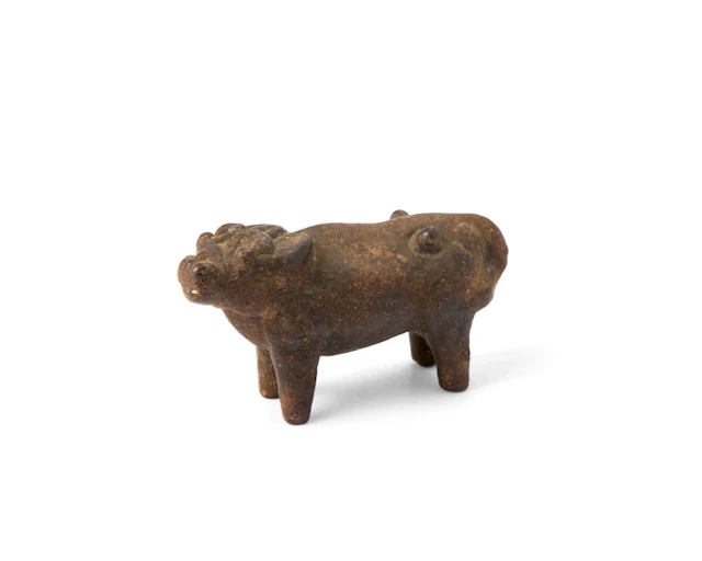 A Chinese iron scroll weight in the form of a buffalo...