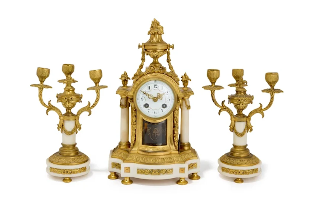 A French gilt-bronze and Carrara marble clock garniture