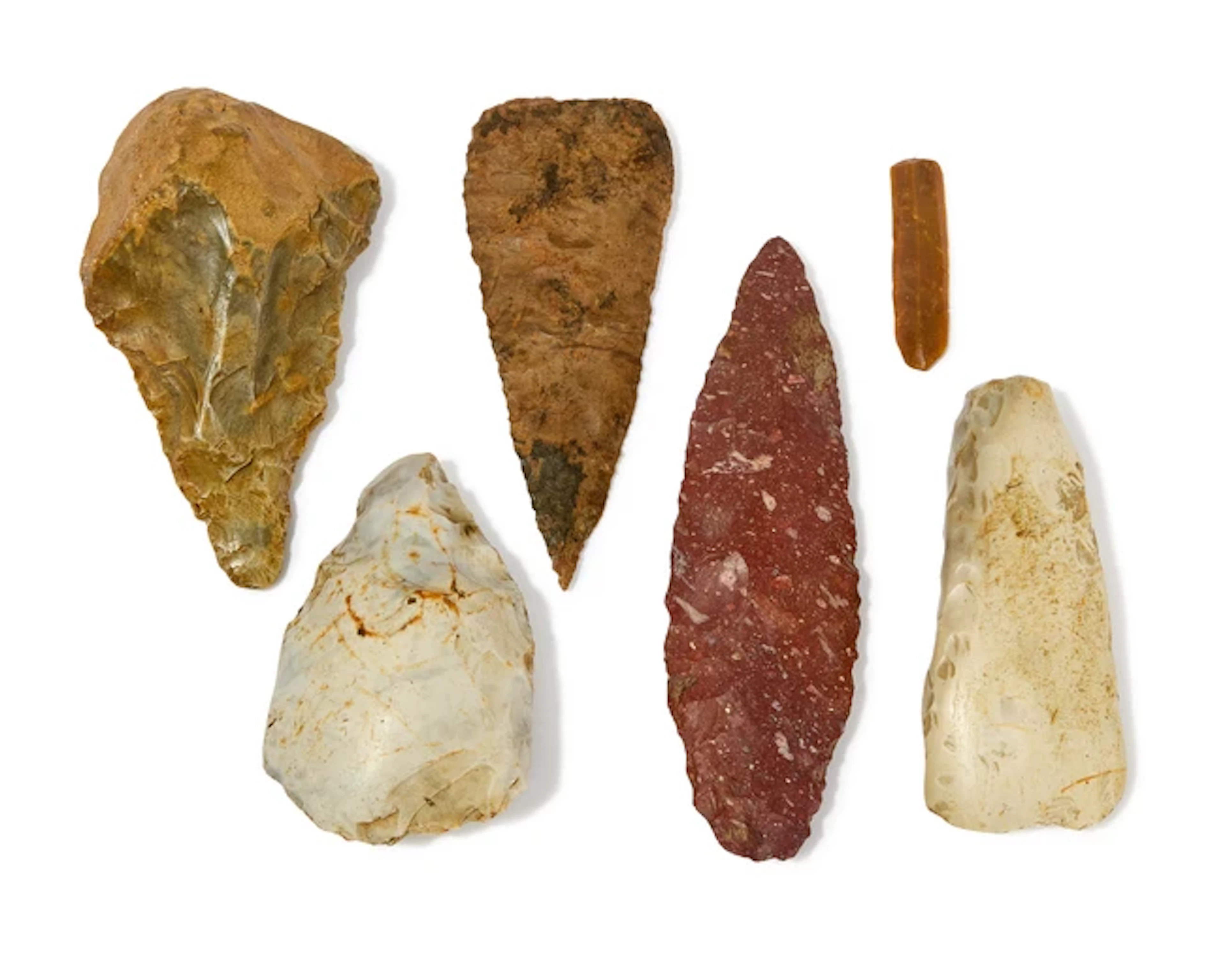 A collection of stone hand tools and weapons