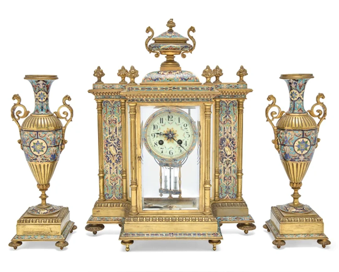 A French gilt-brass and champleve enamel clock garniture
