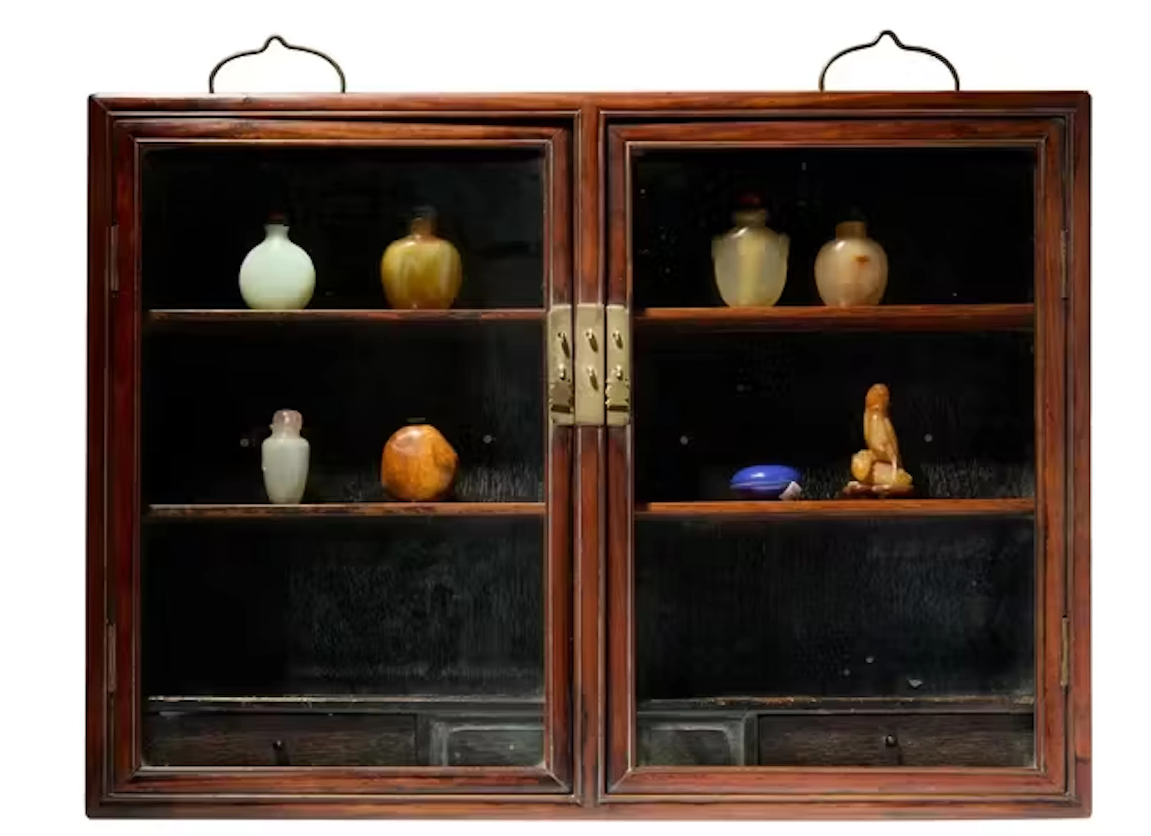 A Chinese hardwood cabinet and seven snuff bottles