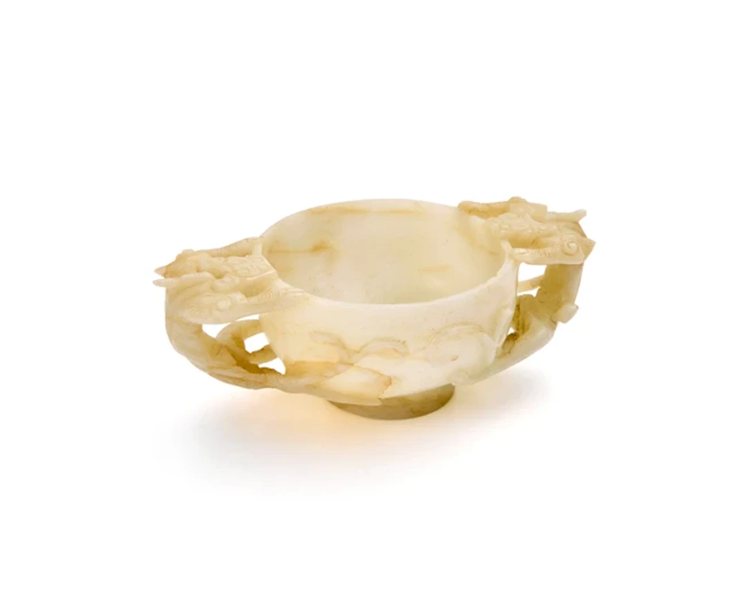 A Chinese white jade archaistic two-handled cup Late Qing...