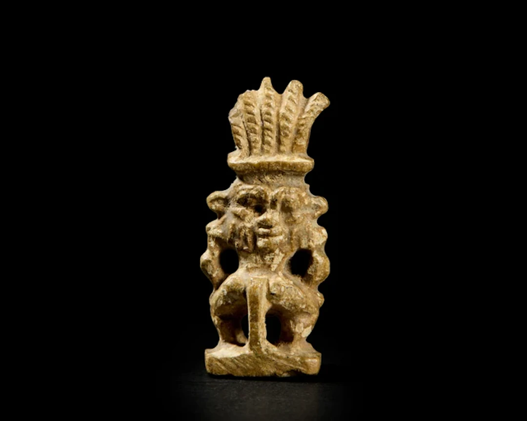 An Egyptian glazed steatite amulet of a janus-headed Bes