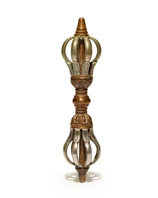 A Tibetan silvered bronze and copper-alloy eight-pronged...
