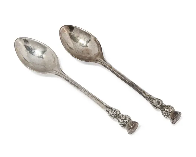 A pair of Arts & Crafts silver teaspoons with thistle finials
