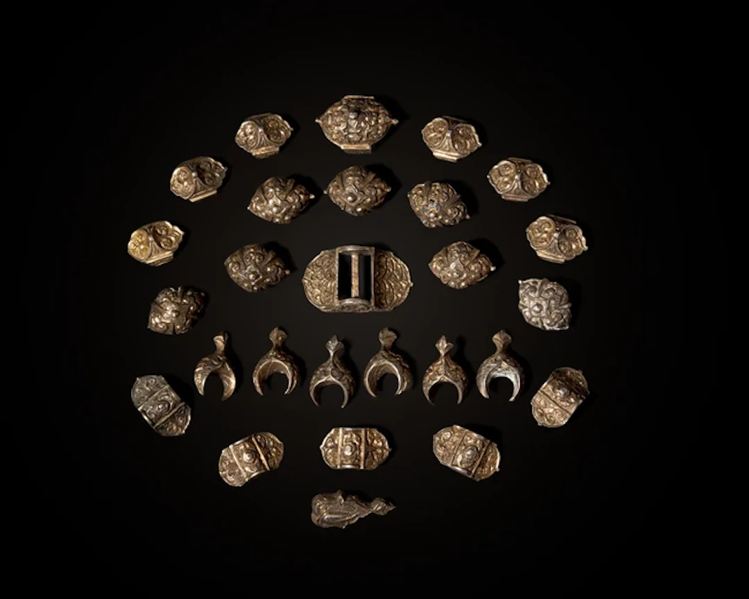 A group of gilt silver repoussé belt mounts