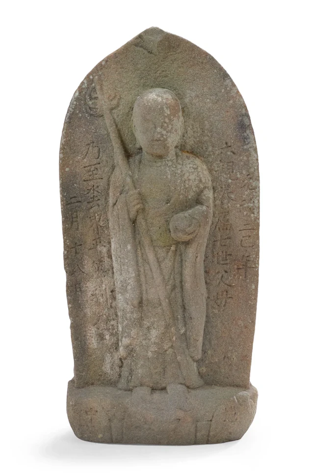 A Japanese stone figure of standing Jizo Bosatso...