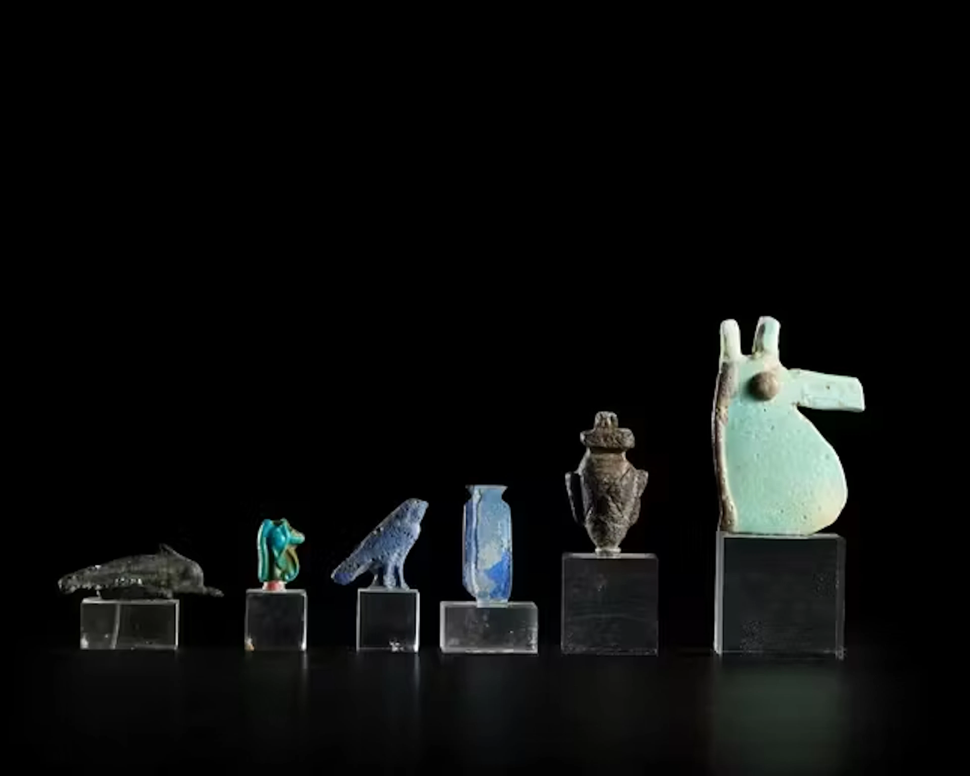 Five Egyptian faience and glass amulets and inlays,Late...