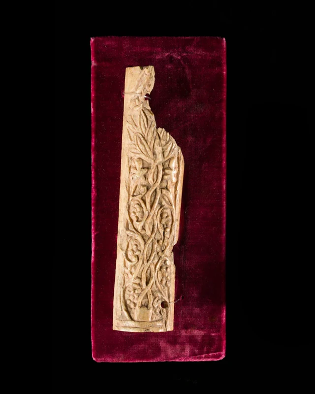 An Umayyad carved bone panel decorated with scrolling vines and grape clusters