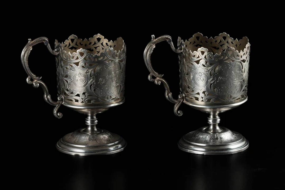 A pair of silver openwork engraved footed cups