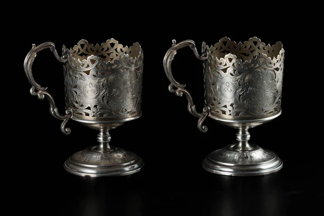 A pair of silver openwork engraved footed cups
