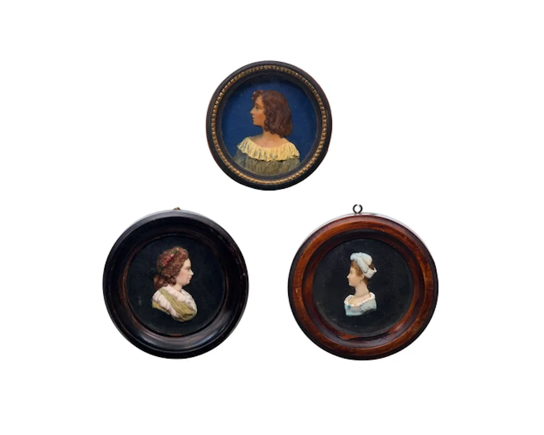 A group of three English polychrome wax portrait reliefs of ladies