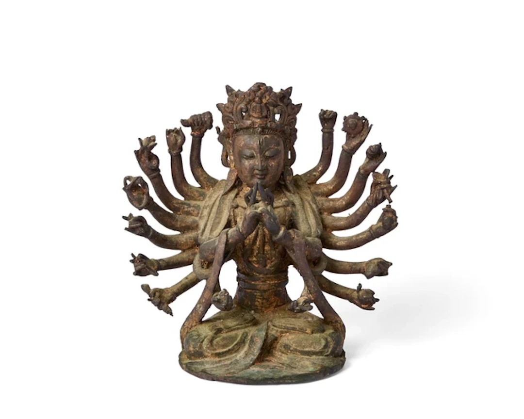 A Chinese gilt-lacquered bronze figure of multi-armed...