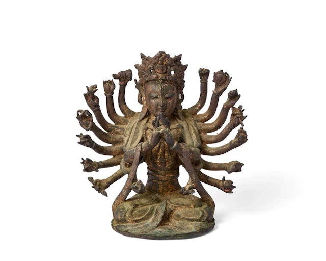 A Chinese gilt-lacquered bronze figure of multi-armed...