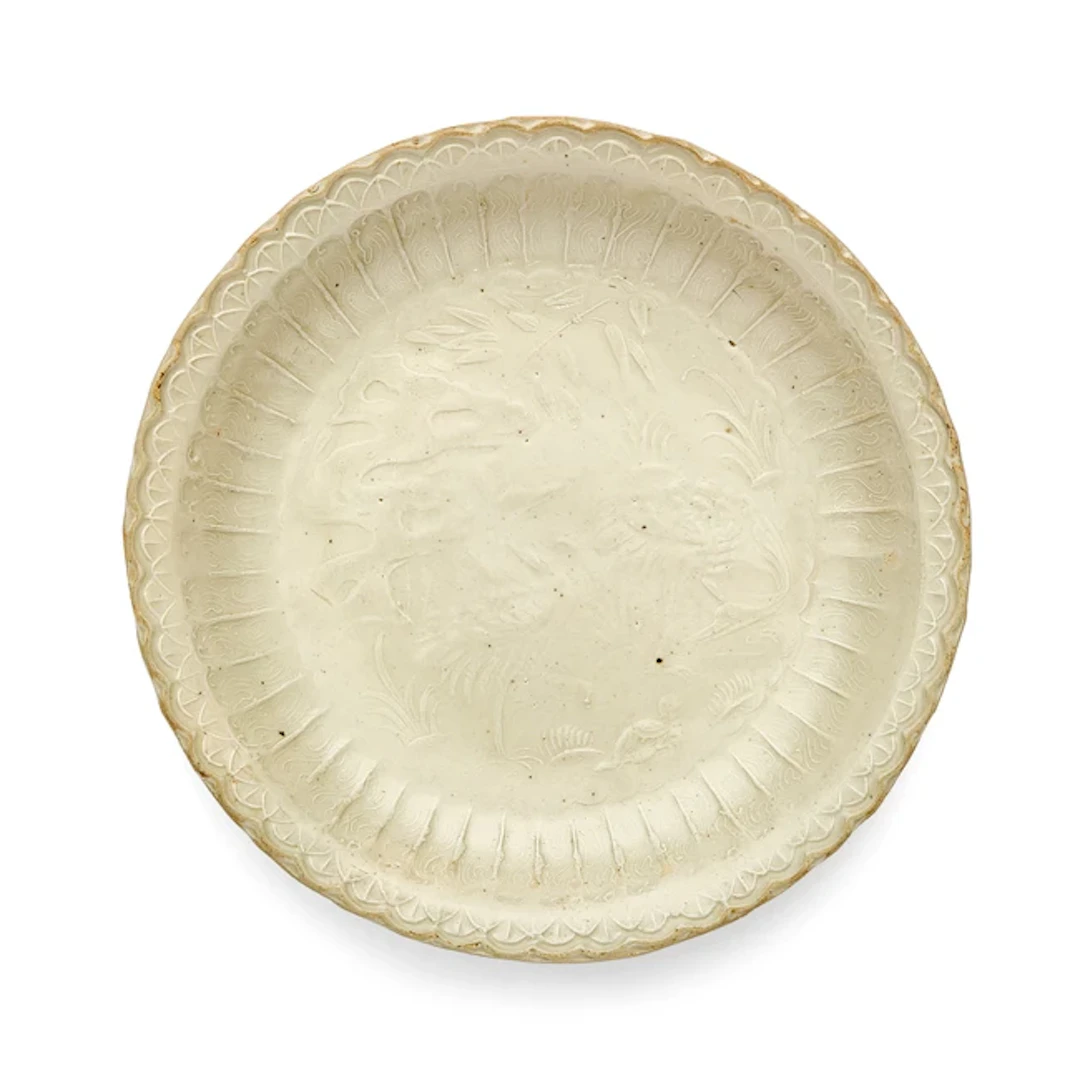 A rare Chinese Ding moulded 'cranes and tortoise' dish Jin dynasty