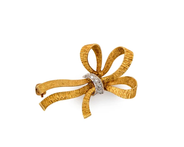 An 18ct gold diamond set bow brooch