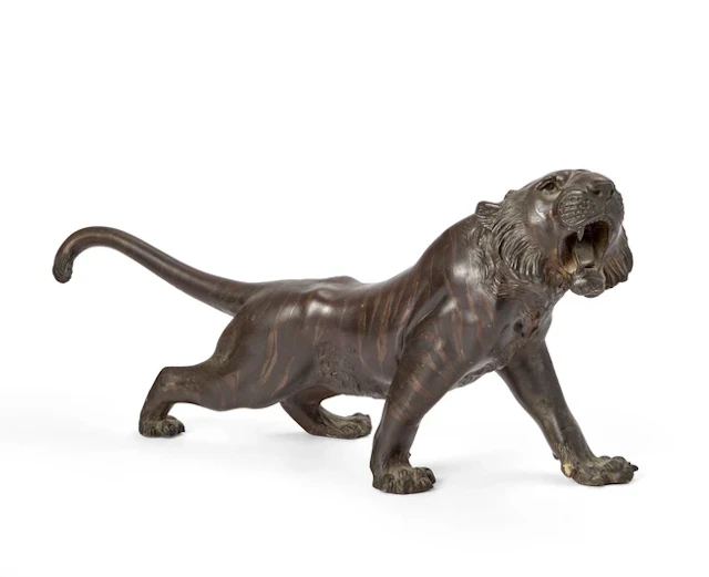 A large Japanese bronze okimono of a prowling tiger Meiji...