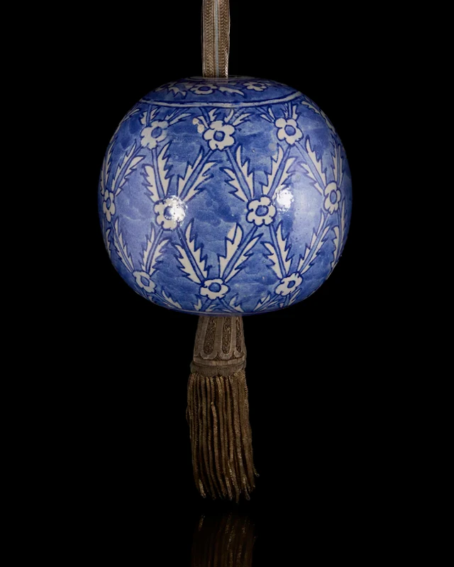 A spherical hanging blue and white pottery ornament