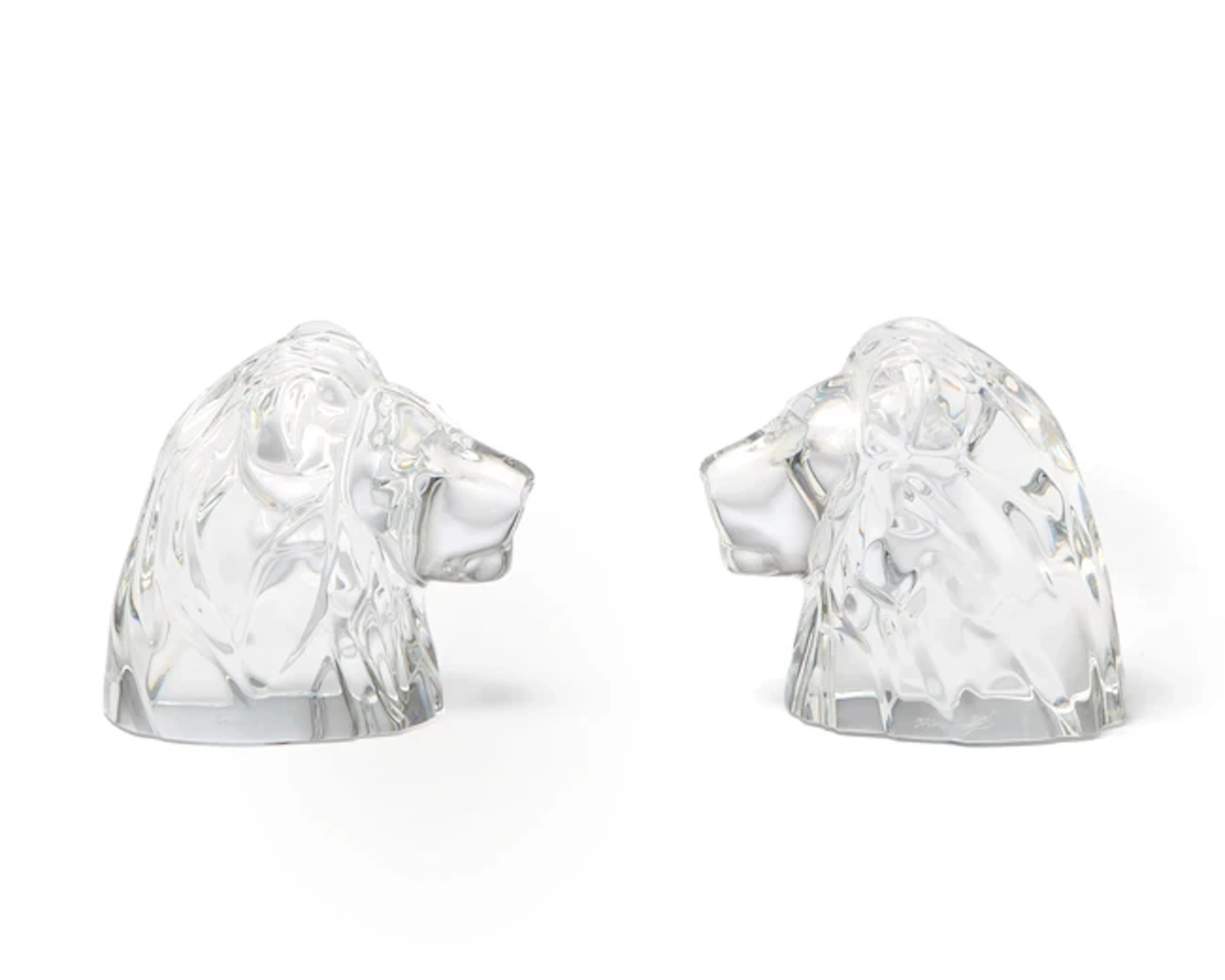 A pair of Baccarat crystal paperweights modelled as lion heads