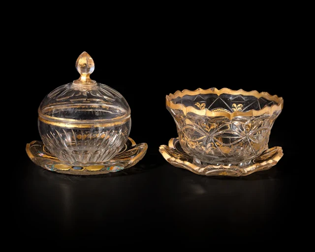 Two gilt and cut clear glass bowl and their associated dishes