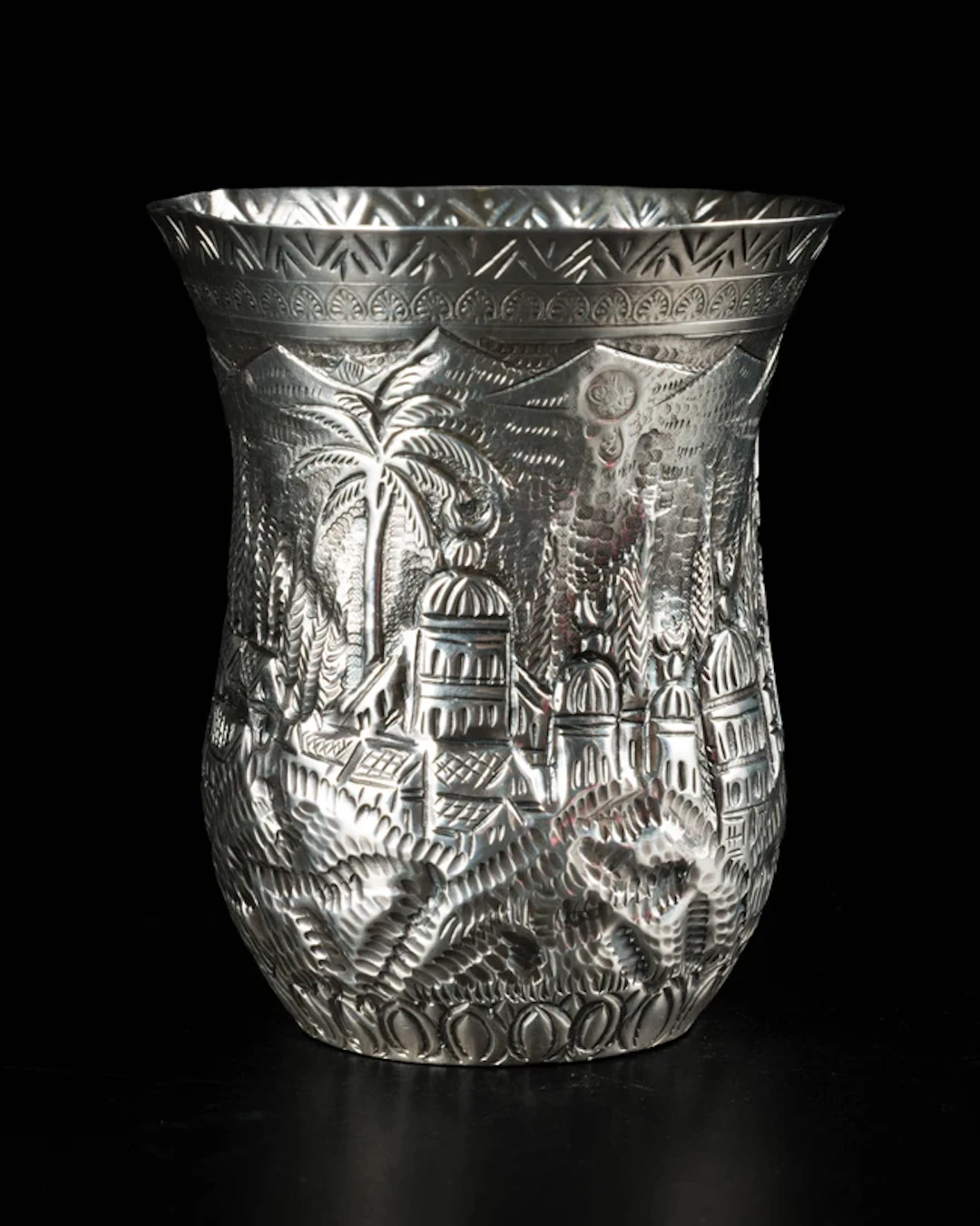 A repousse work silver cup with village scene