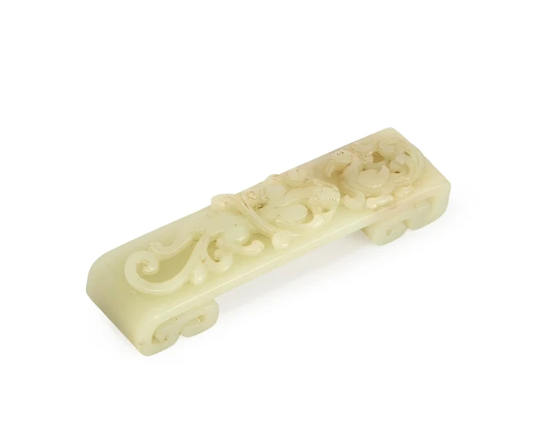 A Chinese celadon jade archaistic 'chilong and phoenix'...